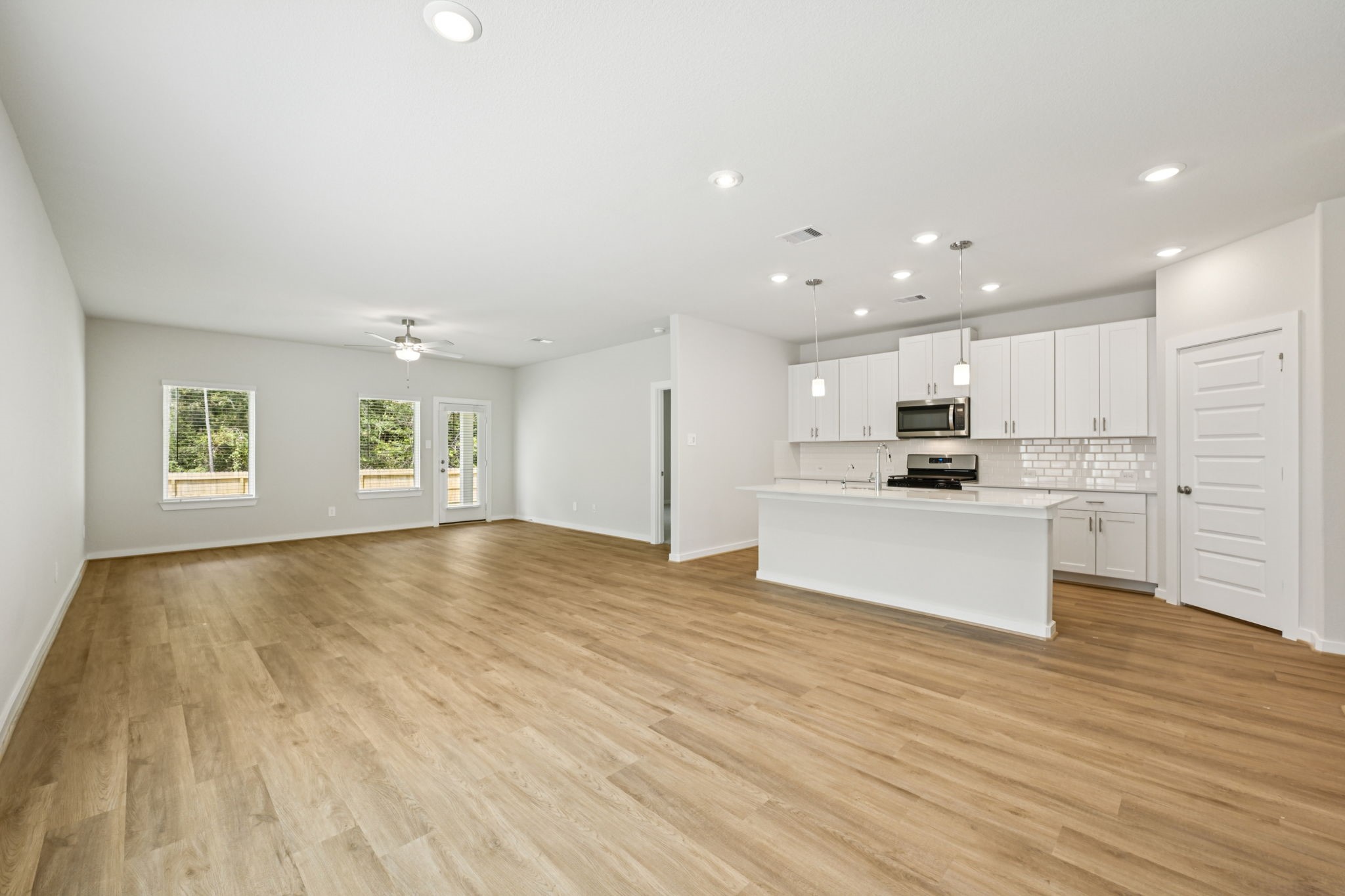 1653 Hopson Ranch Drive Conroe, TX 77301 - Photo 8 of 38 a view of kitchen with granite countertop cabinets and refrigerator