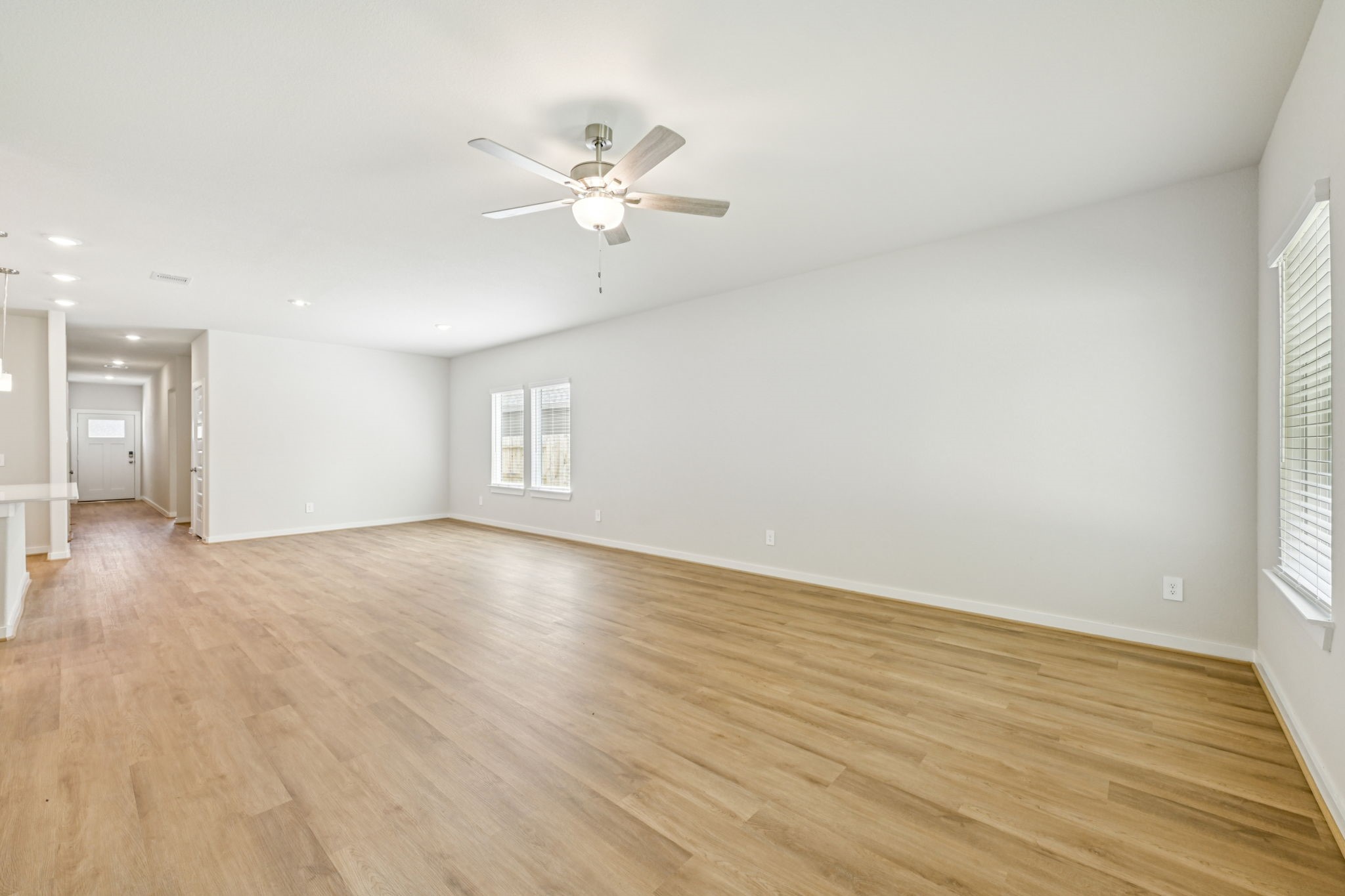 1653 Hopson Ranch Drive Conroe, TX 77301 - Photo 9 of 38 a view of an empty room with wooden floor and a window