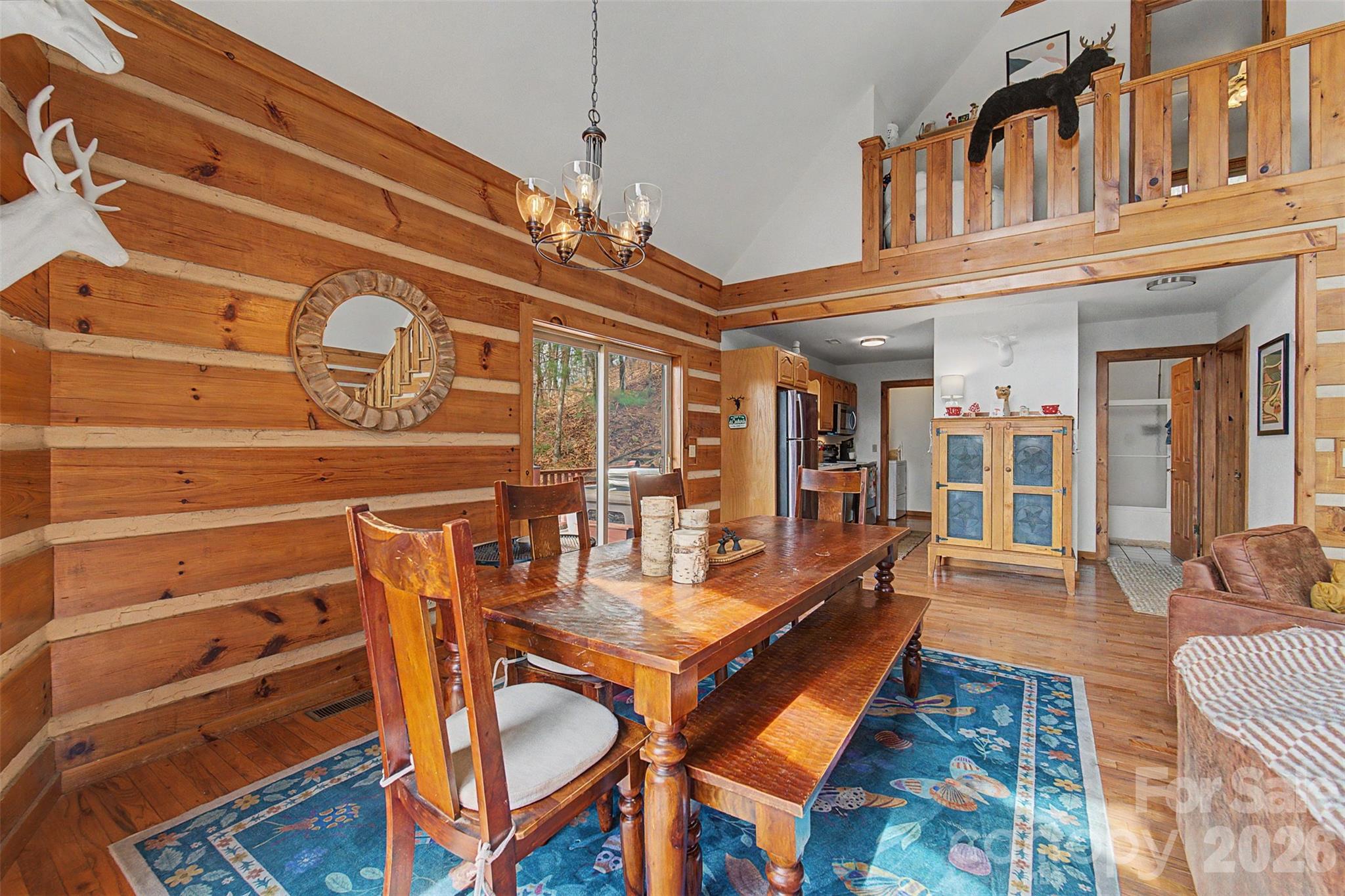 183 Ridge Place Bryson City, NC 28713 - Photo 14 of 44 a view of a dining room with furniture wooden floor and chandelier