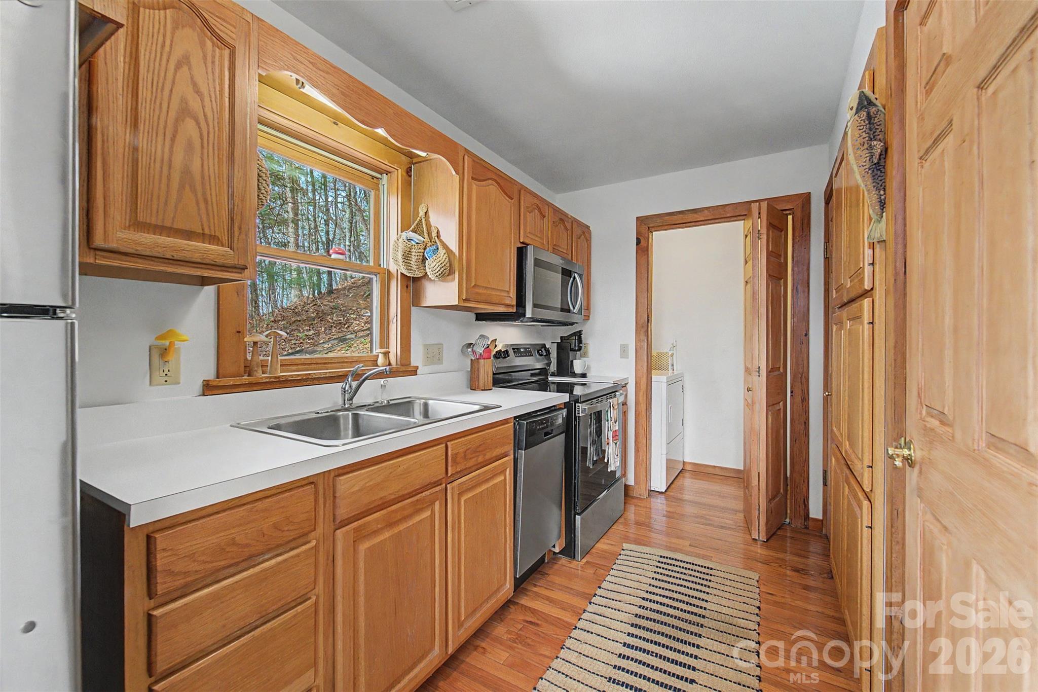 183 Ridge Place Bryson City, NC 28713 - Photo 15 of 44 a kitchen with stainless steel appliances granite countertop a sink stove and cabinets