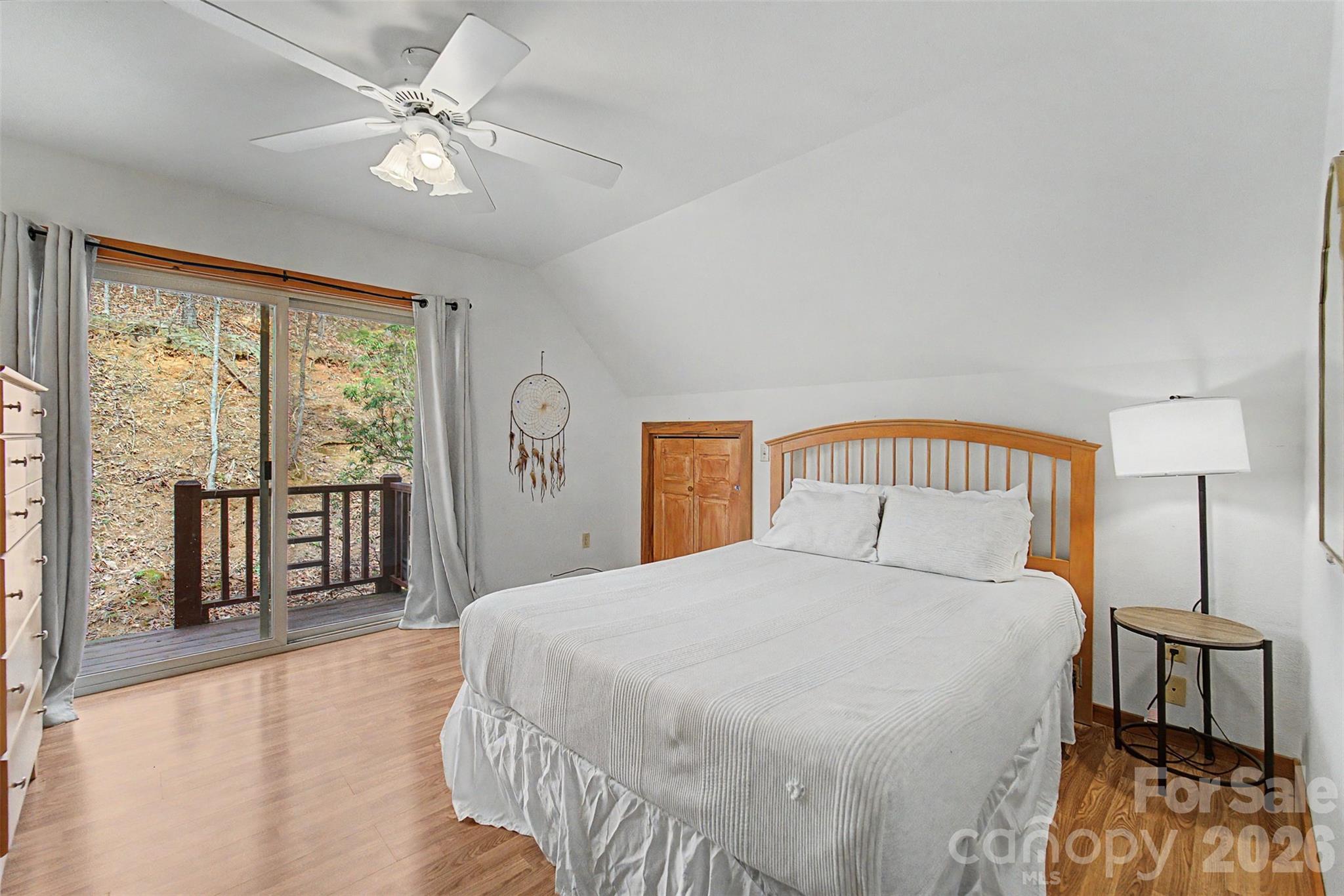 183 Ridge Place Bryson City, NC 28713 - Photo 22 of 44 a bedroom with a large bed and a chandelier