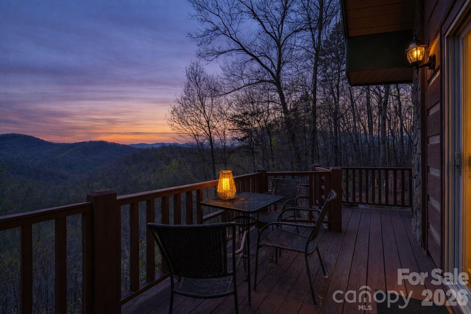 183 Ridge Place Bryson City, NC 28713 - Photo 3 of 44 a view of a roof deck with table and chairs with wooden floor and fence