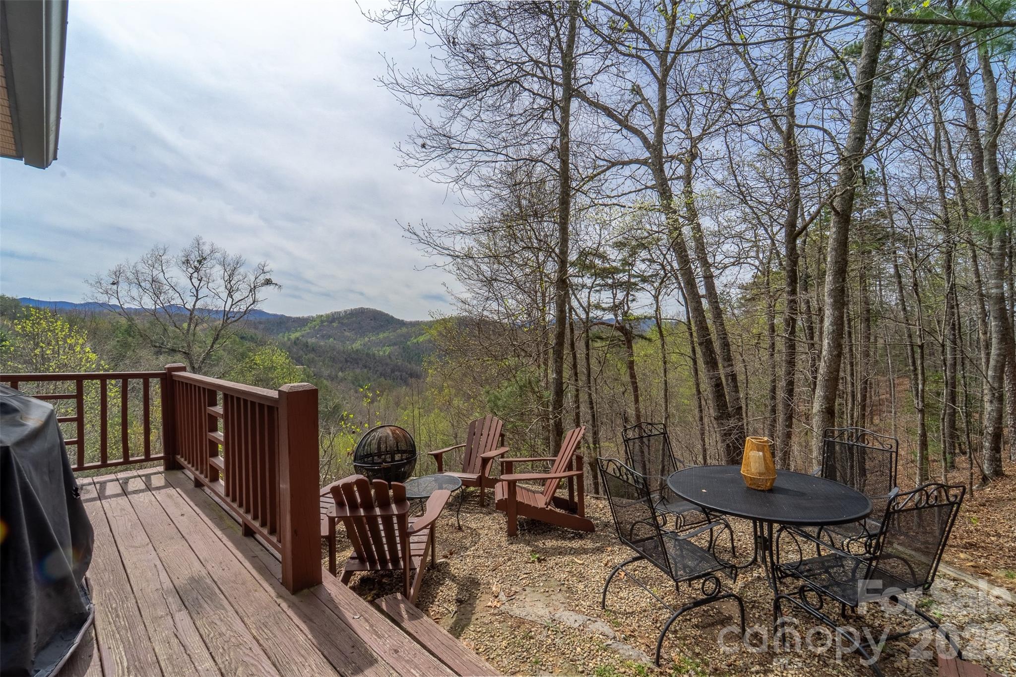 183 Ridge Place Bryson City, NC 28713 - Photo 32 of 44 a view of a balcony with chairs and wooden floor