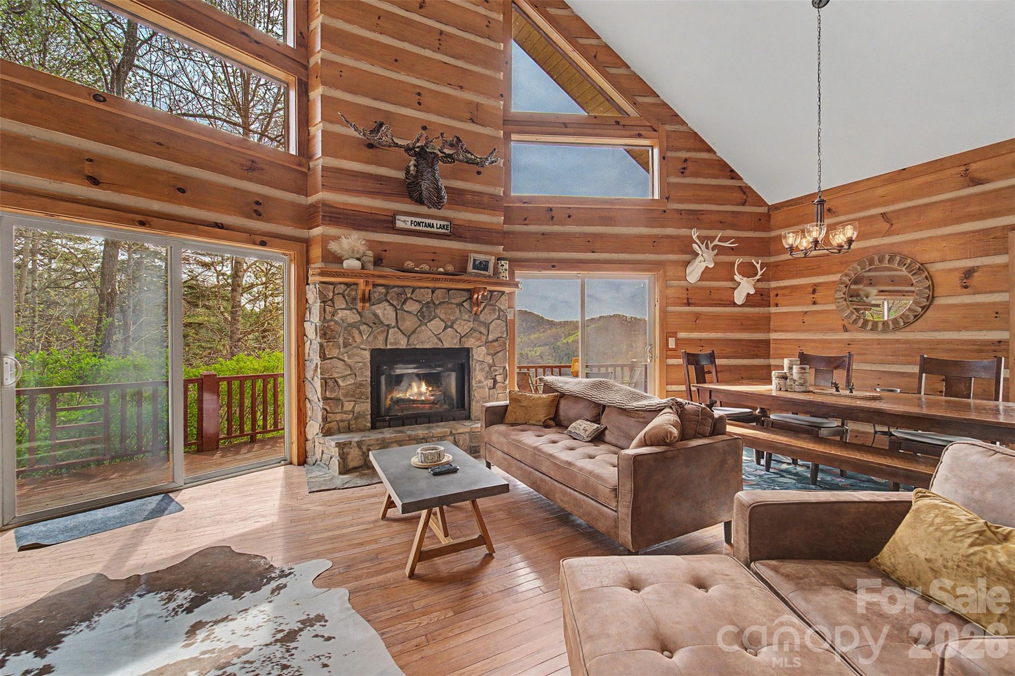 183 Ridge Place Bryson City, NC 28713 - Photo 7 of 44 a living room with furniture wooden floor and a fireplace