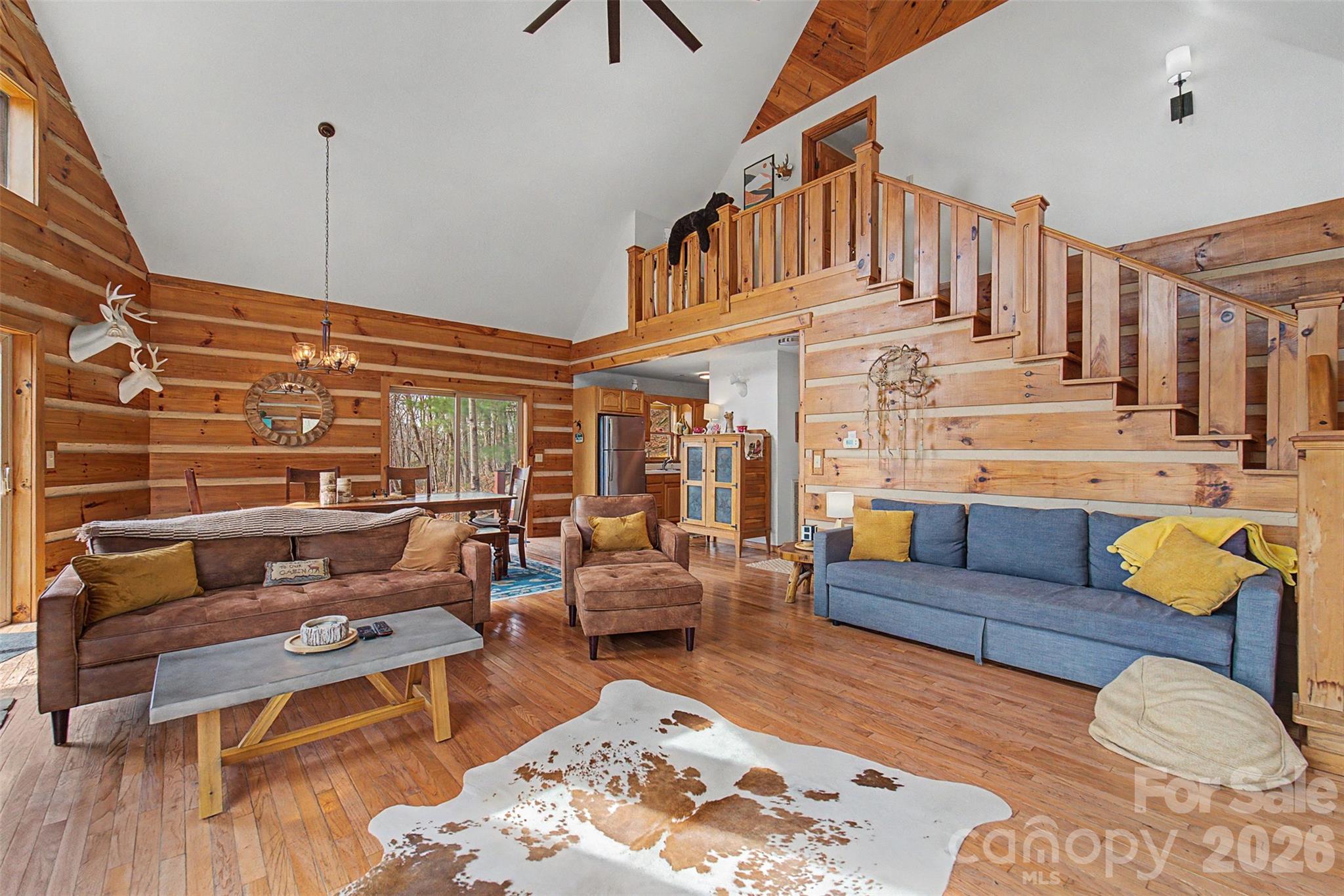183 Ridge Place Bryson City, NC 28713 - Photo 10 of 44 a living room with furniture a rug and a chandelier
