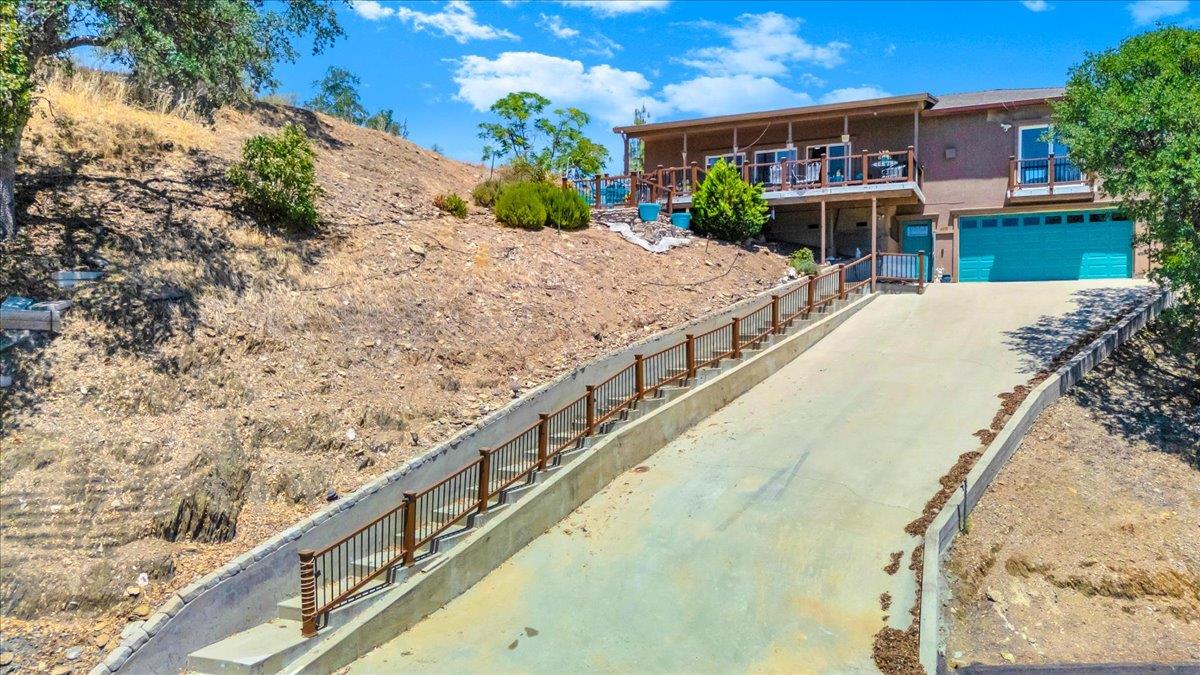 411 Sunrise Road Copperopolis, CA 95228 - Photo 2 of 76 Concrete pathway up to the house for visitors and long, paved driveway leading to a 4-car tandem garage to park your boat and toys!