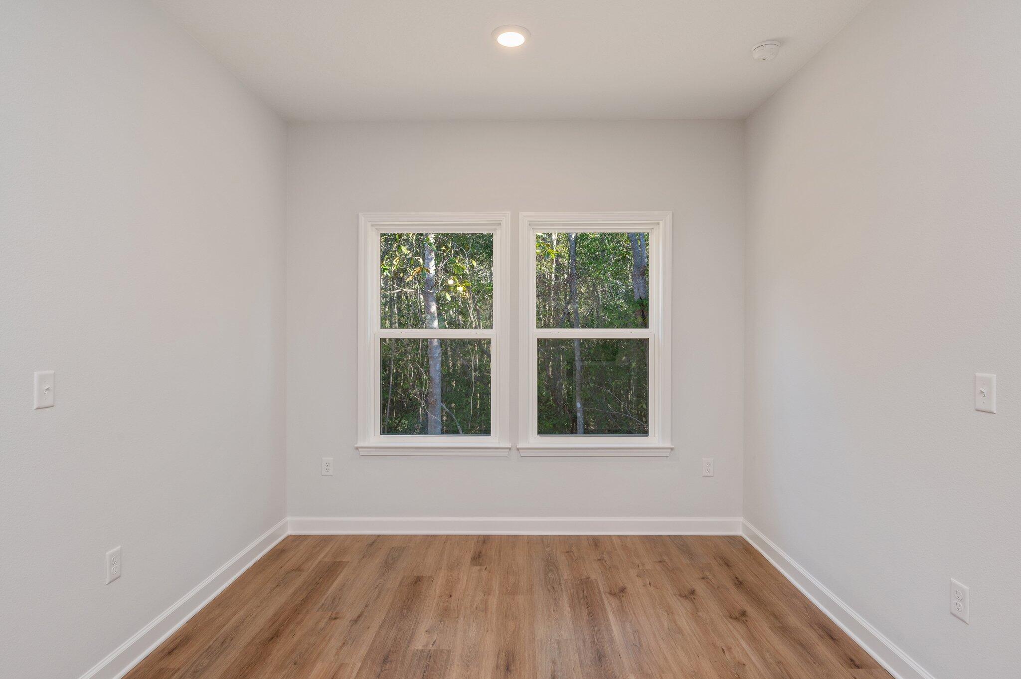 2614 Sorrel Ridge Road Crestview, FL 32536 - Photo 14 of 35 an empty room with wooden floor and windows