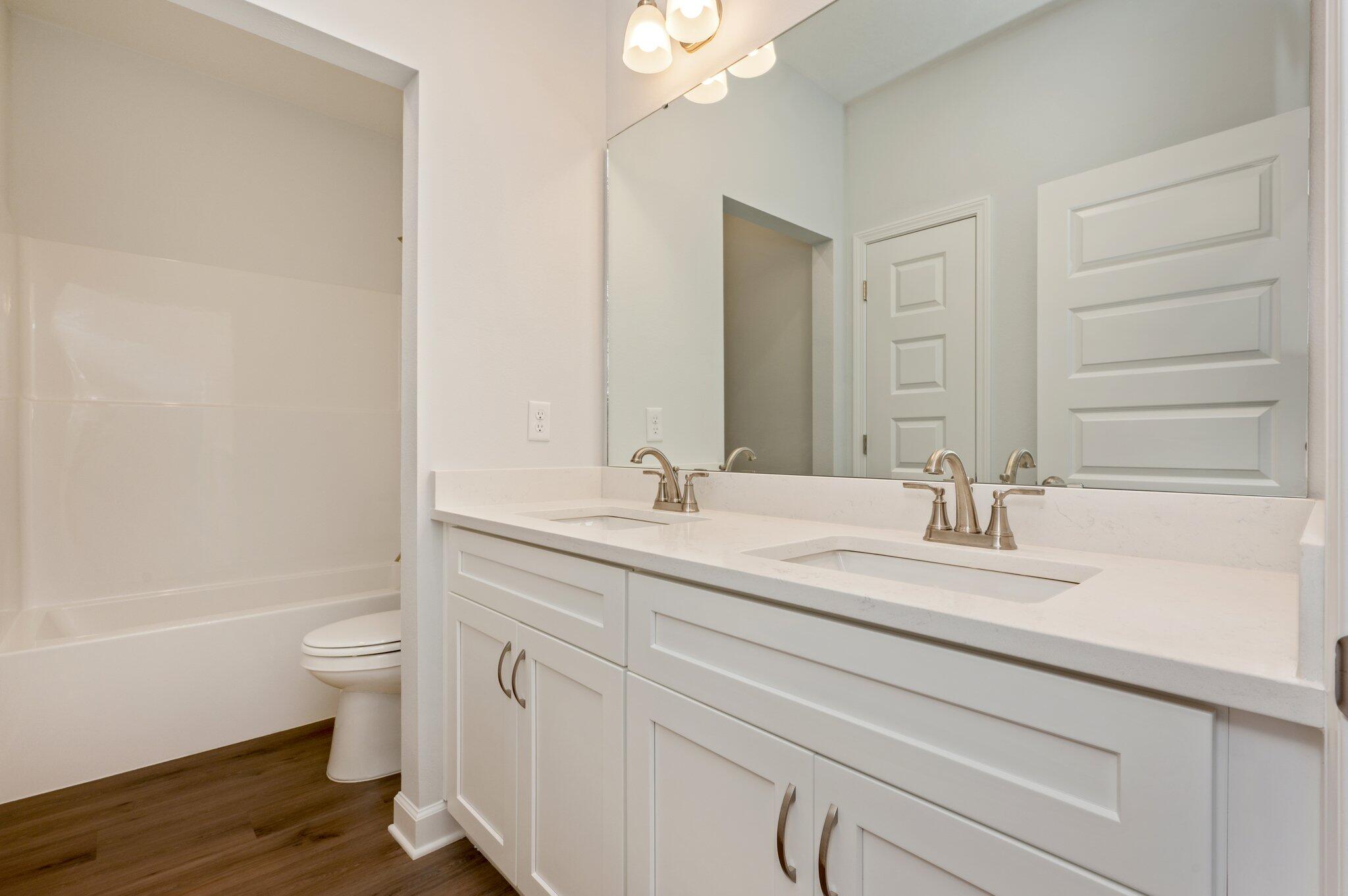 2614 Sorrel Ridge Road Crestview, FL 32536 - Photo 30 of 35 a bathroom with a granite countertop sink a toilet and a large mirror