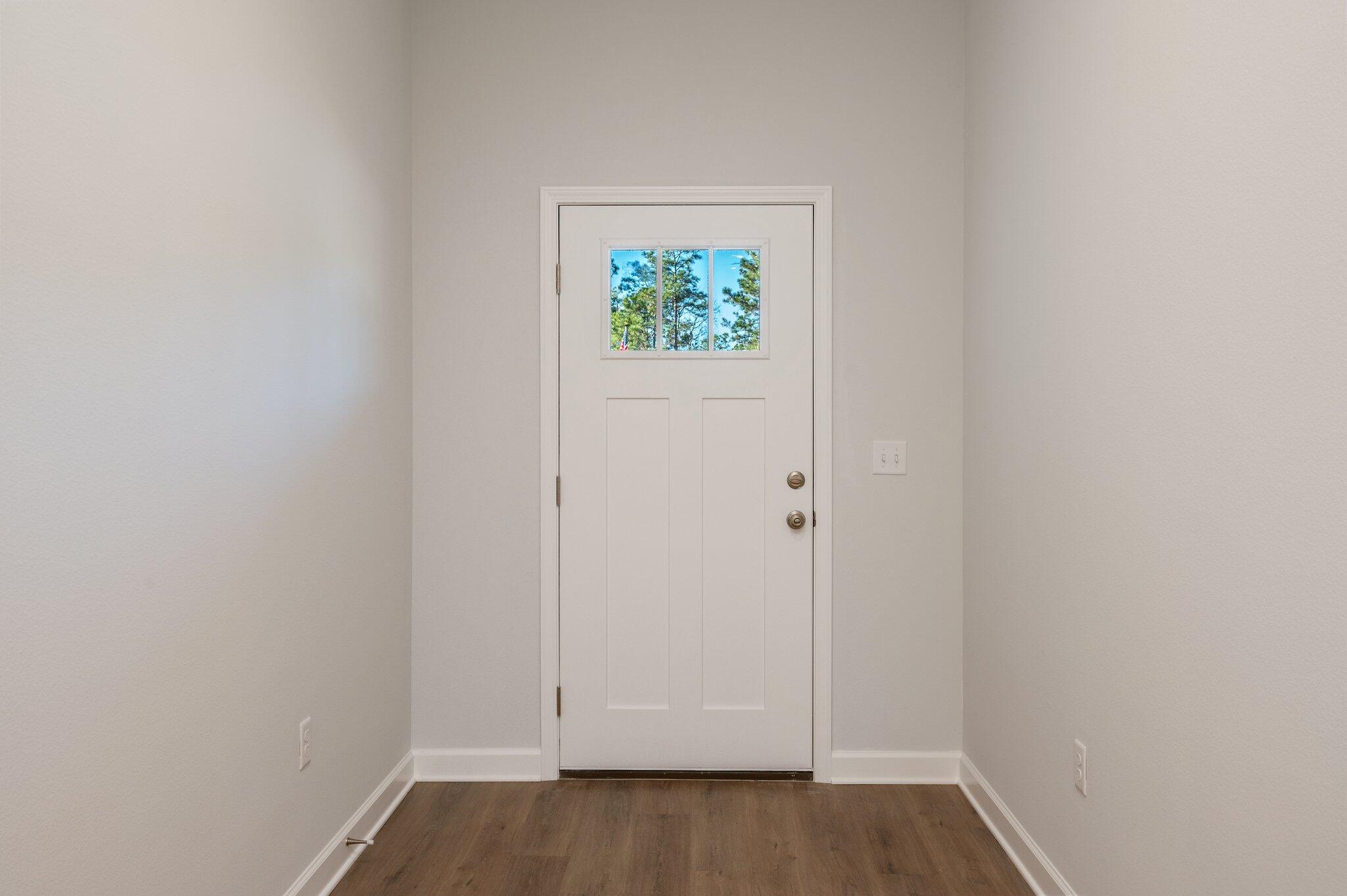 2614 Sorrel Ridge Road Crestview, FL 32536 - Photo 4 of 35 a view of an empty room with wooden floor and window