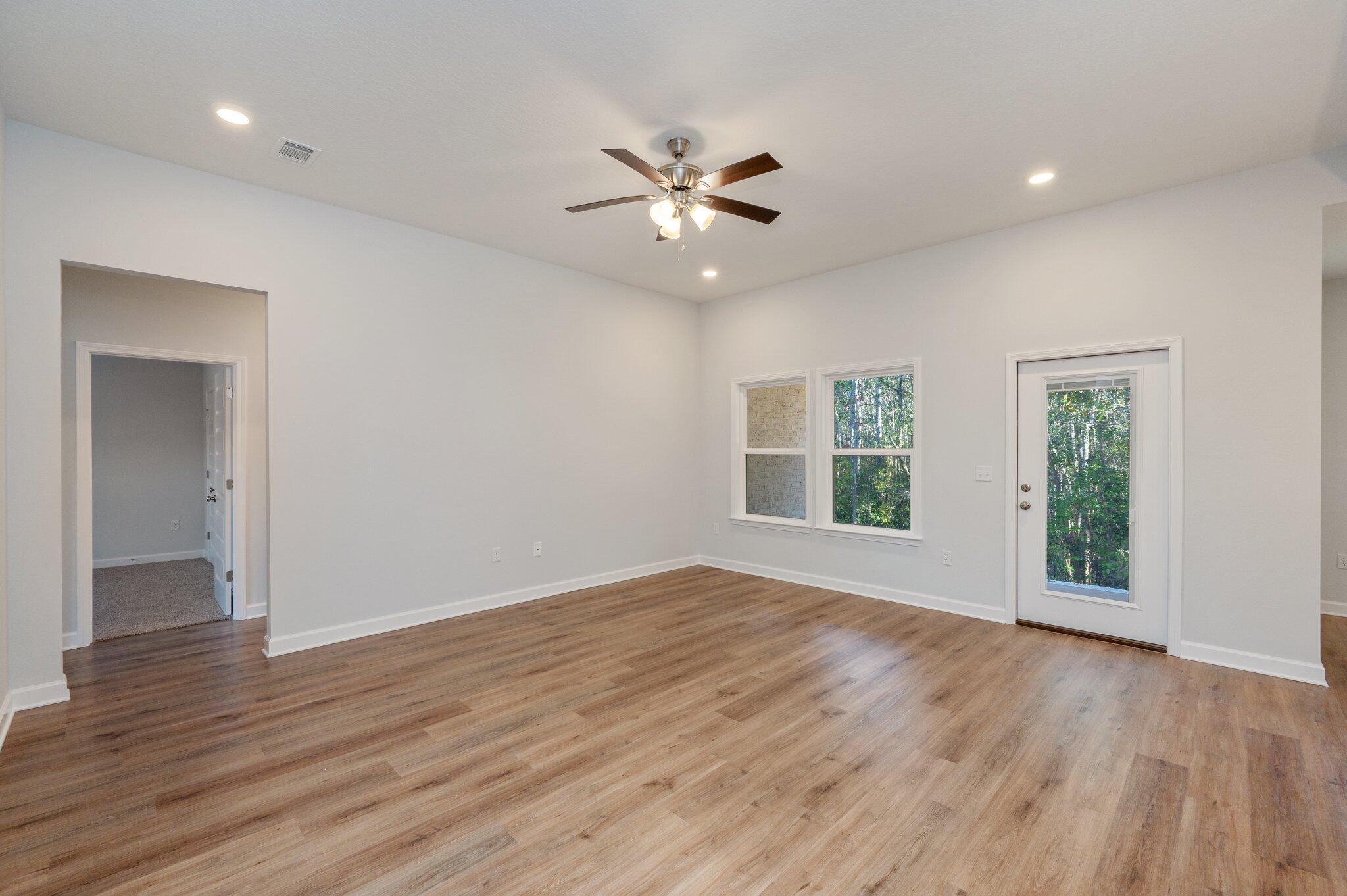 2614 Sorrel Ridge Road Crestview, FL 32536 - Photo 5 of 35 a view of an empty room with wooden floor and a window