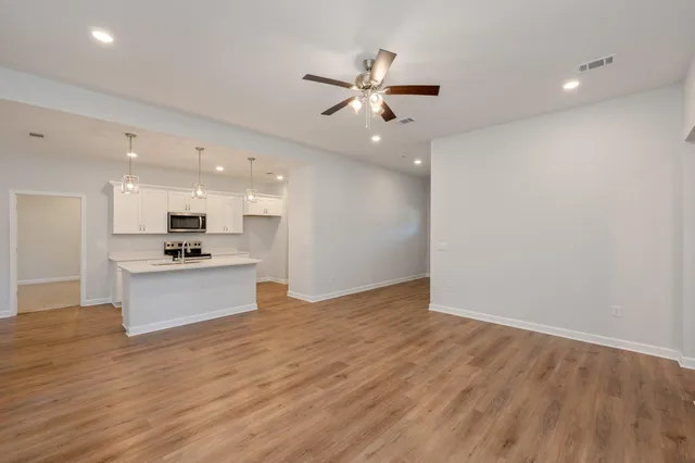 a view of kitchen with cabinets and wooden floor