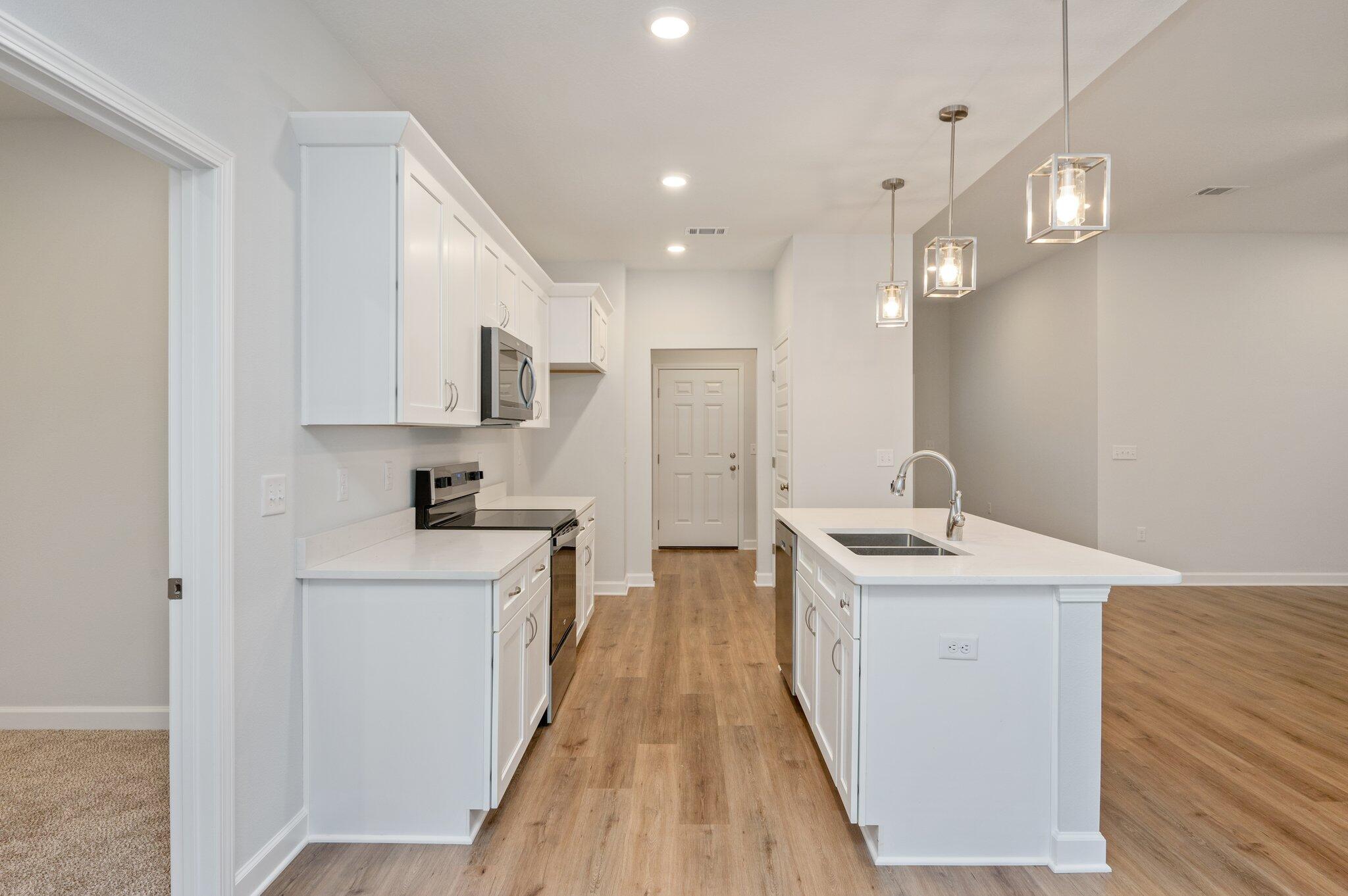 2614 Sorrel Ridge Road Crestview, FL 32536 - Photo 10 of 35 a kitchen with stainless steel appliances granite countertop a sink stove and wooden floor