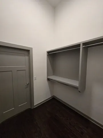 an empty room with wooden floor and closet