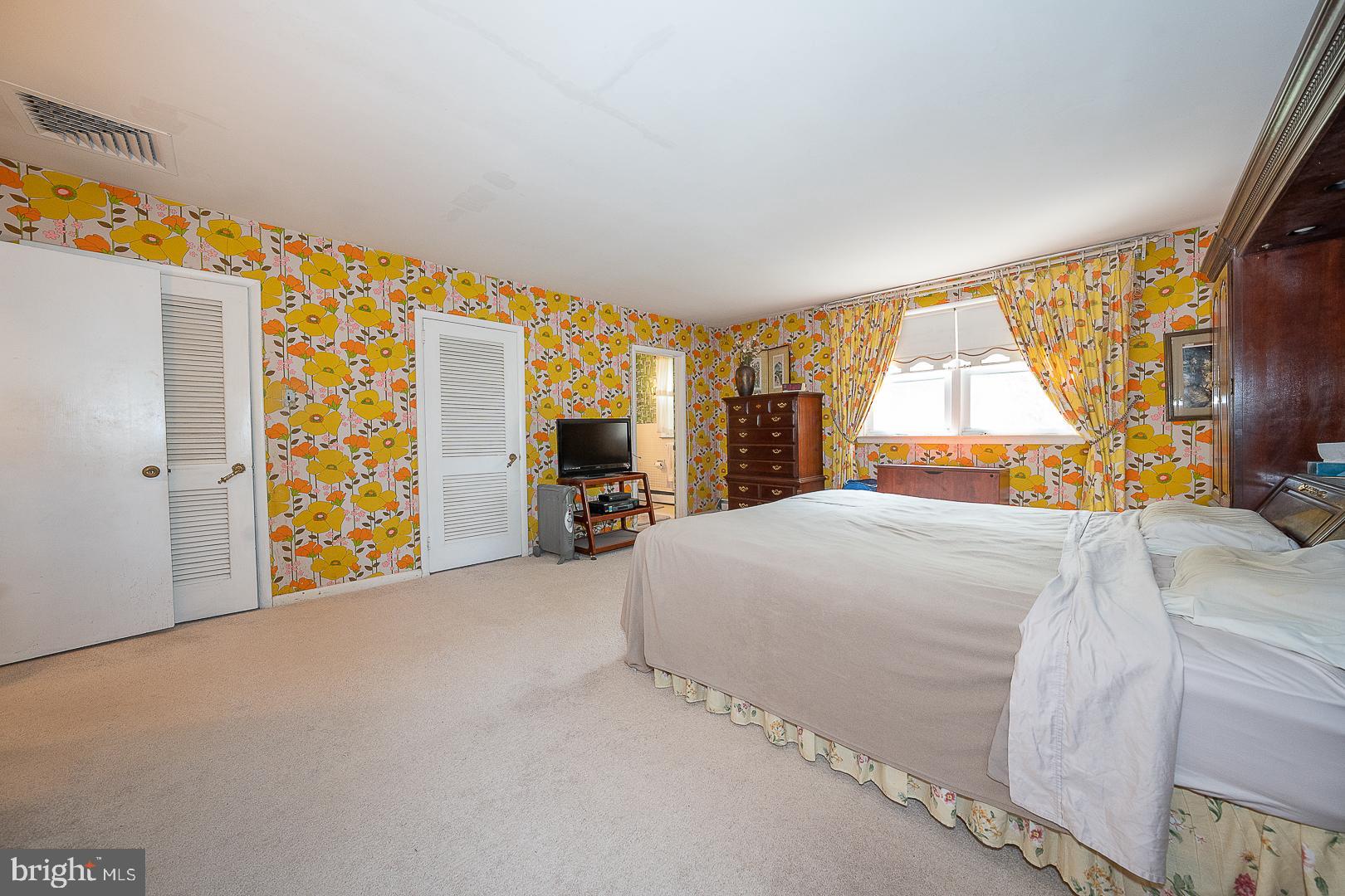 323 Hidden River Road Penn Valley, PA 19072 - Photo 11 of 29 a bedroom with a bed and a large window