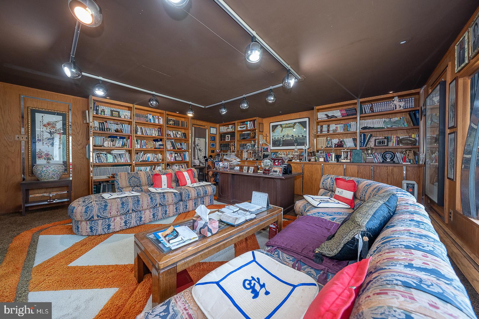 323 Hidden River Road Penn Valley, PA 19072 - Photo 21 of 29 a living room with lots of furniture and a book shelf