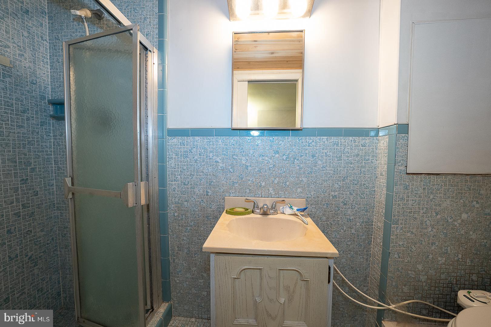 323 Hidden River Road Penn Valley, PA 19072 - Photo 22 of 29 a bathroom with a sink and a mirror