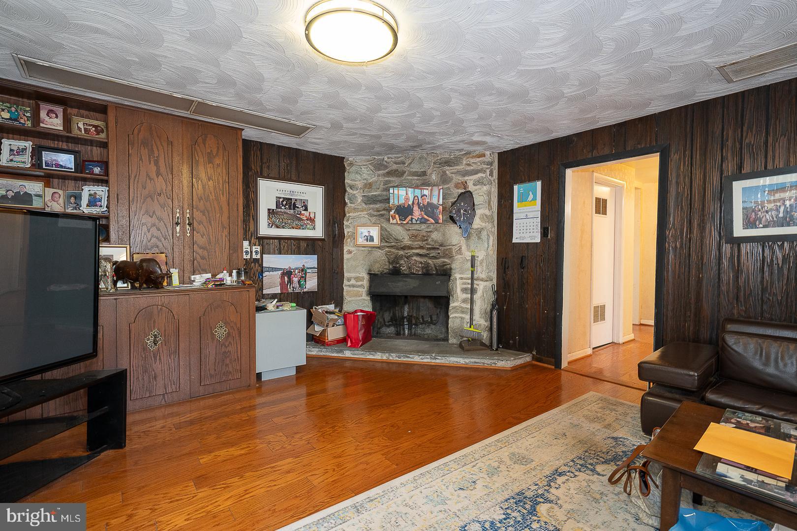 323 Hidden River Road Penn Valley, PA 19072 - Photo 24 of 29 a living room with furniture a flat screen tv and a refrigerator