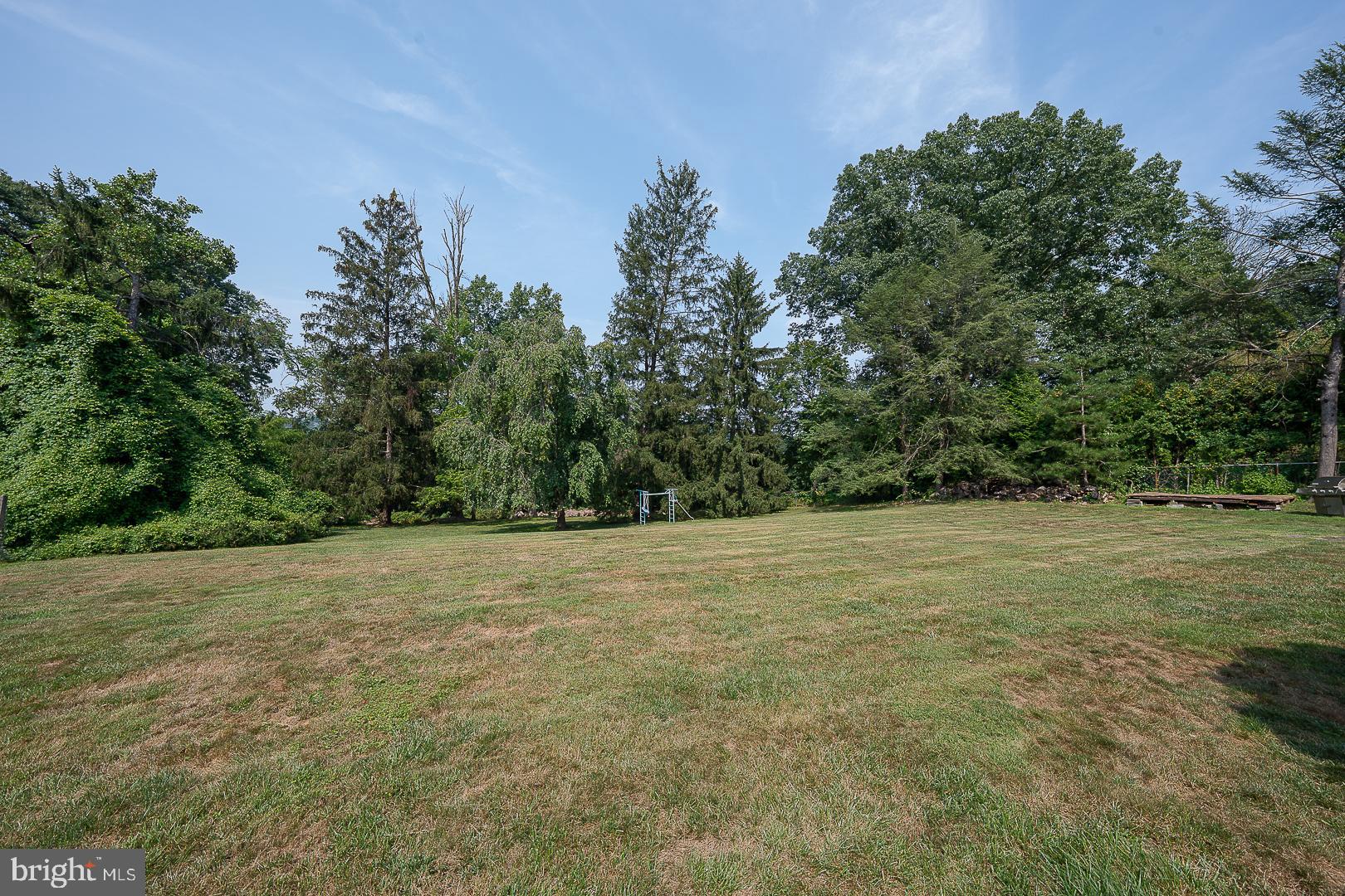 323 Hidden River Road Penn Valley, PA 19072 - Photo 28 of 29 a view of a field with trees in the background