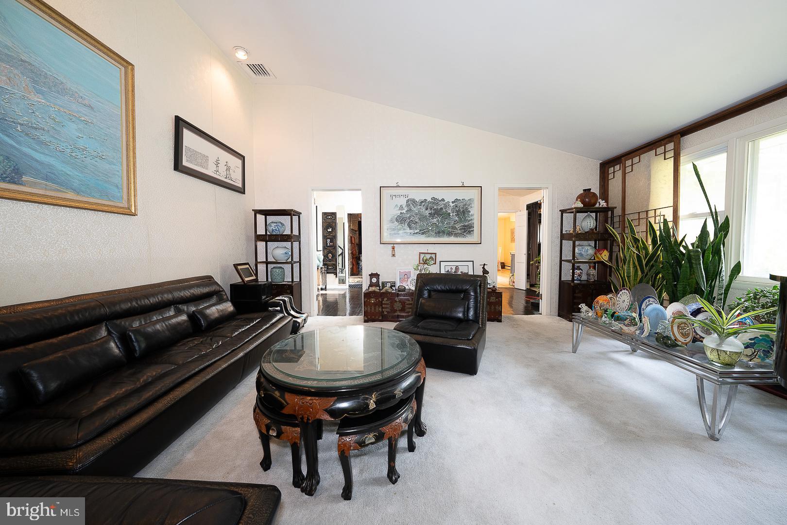 323 Hidden River Road Penn Valley, PA 19072 - Photo 4 of 29 a living room with furniture a flat screen tv and a fireplace