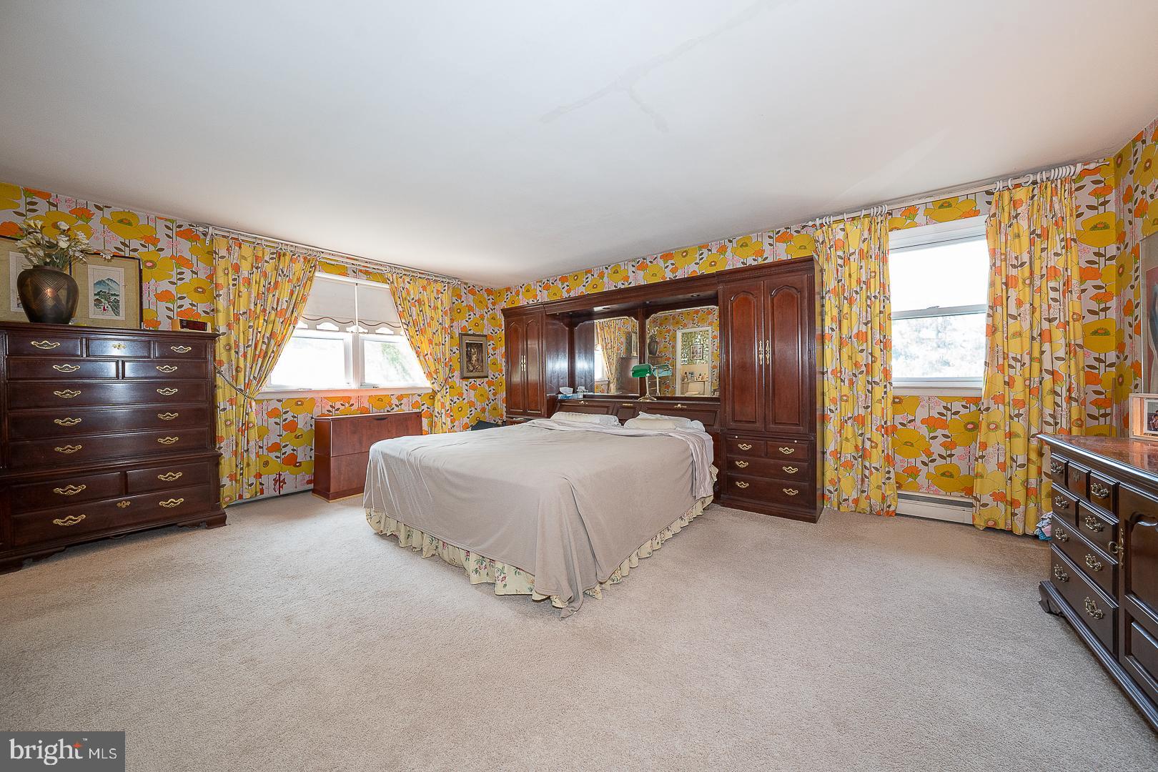 323 Hidden River Road Penn Valley, PA 19072 - Photo 10 of 29 a spacious bedroom with a bed and a large window