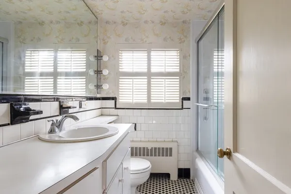 a bathroom with a sink a toilet and tub