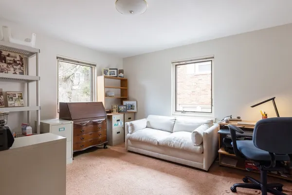 a bedroom with a bed and a desk