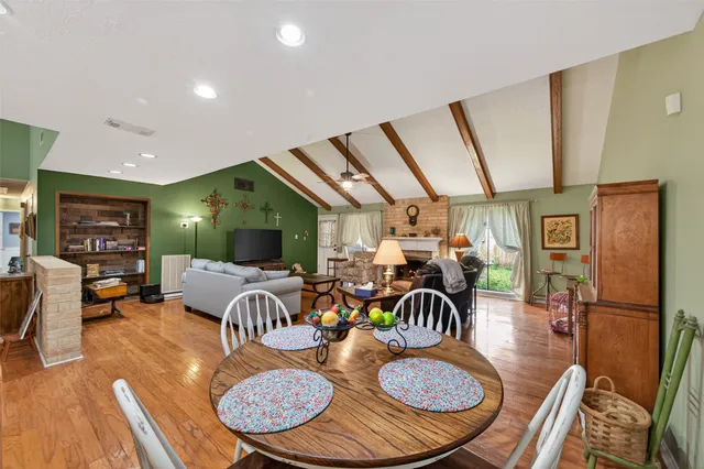 a living room with furniture a fireplace and a large window