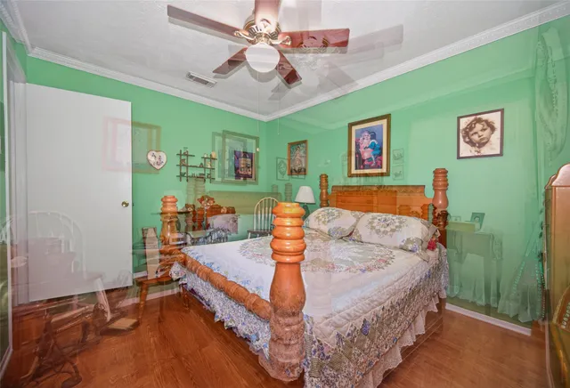 a bedroom with a bed and wooden floor