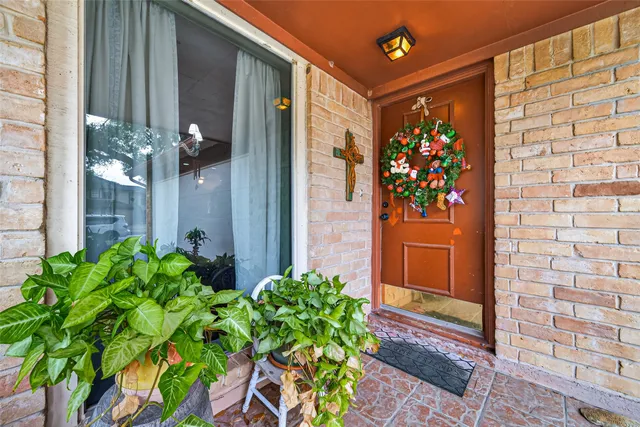 a front view of a house with a flower garden