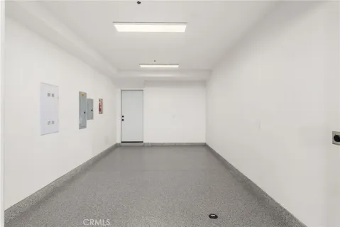 an aerial view of a city with lots of residential buildings and ocean view in back