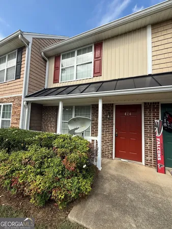 front view of a brick house with a large window