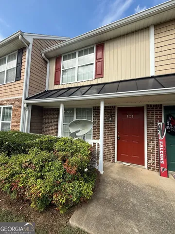front view of a brick house with a large window
