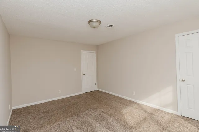 a bathroom with a granite countertop sink toilet a mirror and shower
