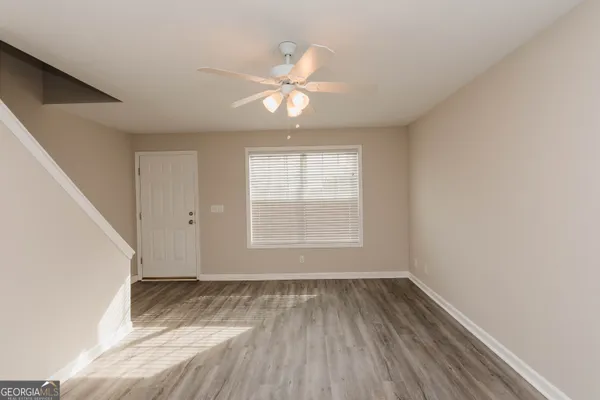 wooden floor in an empty room with a window