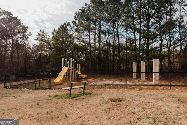 a view of outdoor space with playground and green space