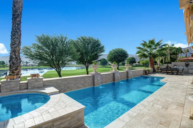 a view of a swimming pool with sitting area