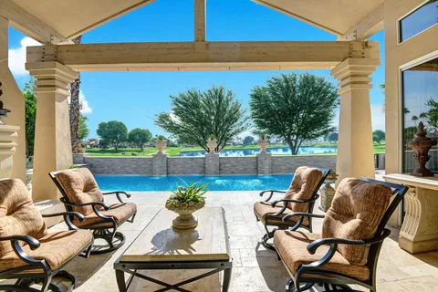 a view of a balcony with chairs and a table