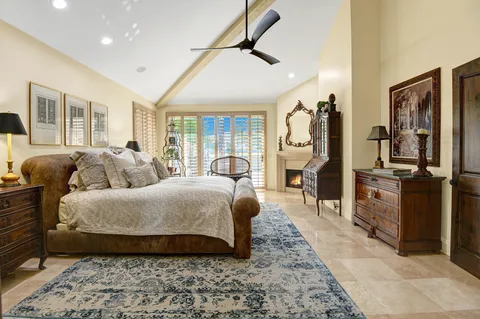 a spacious bedroom with a bed and glass walk in closet