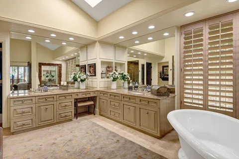 a large bathroom with a large tub and sink