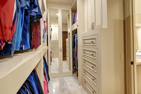 a view of walk in closet with clothes
