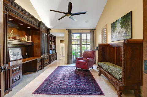 a living room with furniture a flat screen tv and a rug