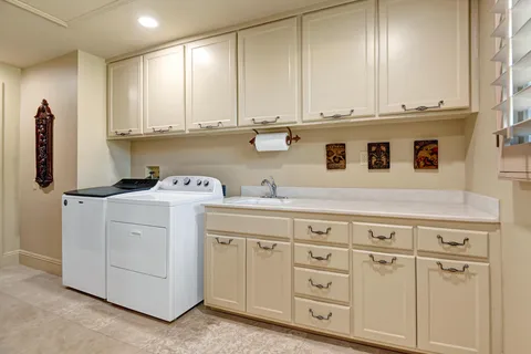 a view of cabinets with washer and dryer