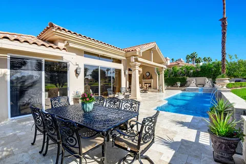 a view of a dinning table and chairs in patio