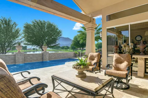 a view of a patio with table and chairs and potted plants