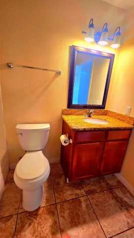 a bathroom with a toilet and a mirror