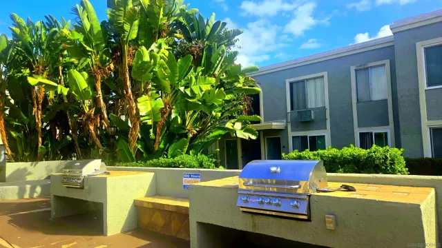 a view of a chairs and table in a back yard of the house