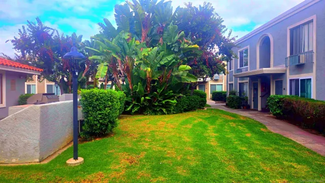 a view of a house with a backyard
