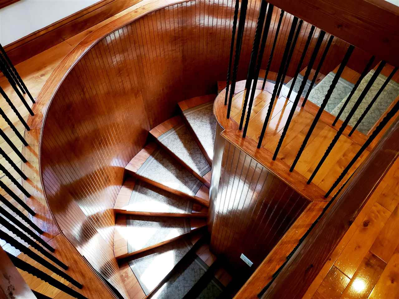 8529 Sawyer Drive Raleigh, NC 27613 - Photo 12 of 28 Rich, wood spiral staircase leads to the downstairs bedroom. Spiral staircase