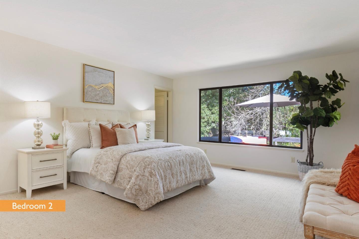 460 Aspen Way Los Altos, CA 94024 - Photo 20 of 30 a spacious bedroom with a bed and a couch