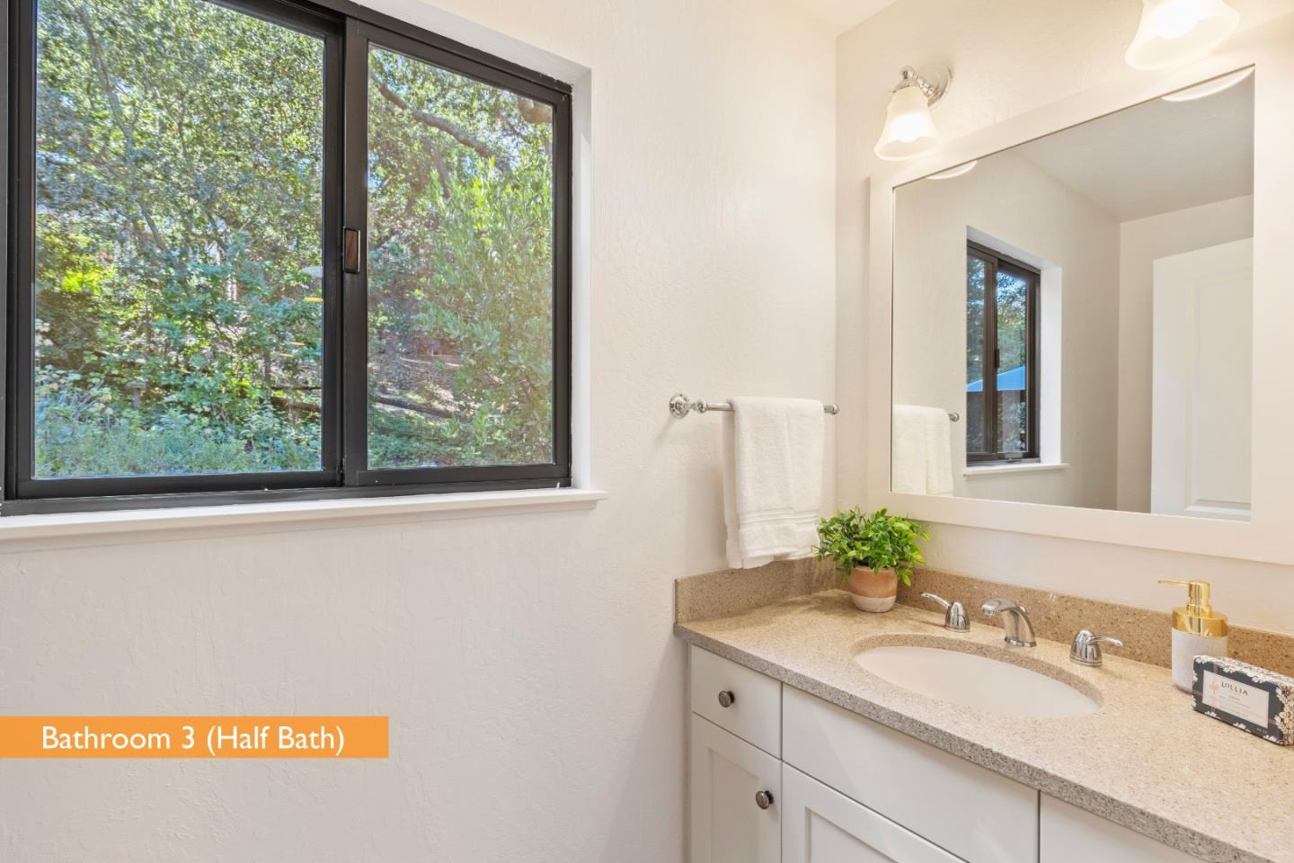 460 Aspen Way Los Altos, CA 94024 - Photo 23 of 30 a bathroom with a sink a mirror and a window